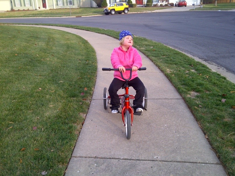 Young child wearing a helmet riding a bicycle
