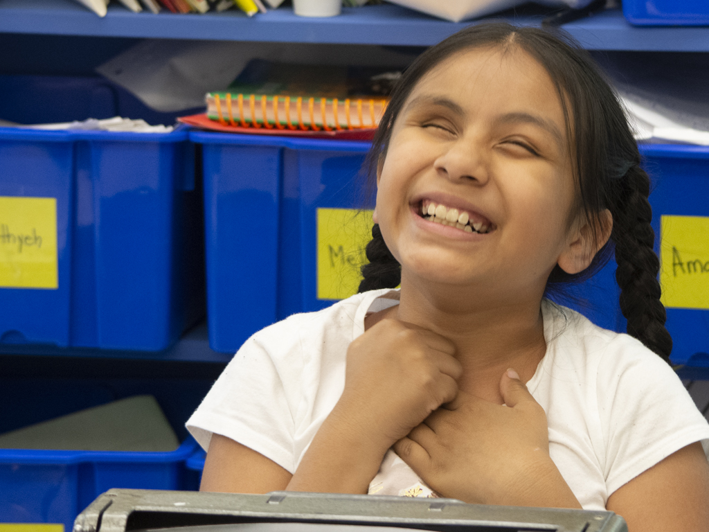 Young blind girl smiling with hands together