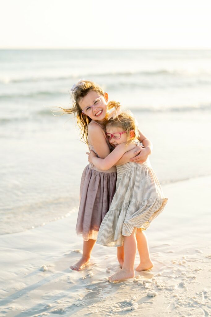 Nadine and Vivian hugging at the beach