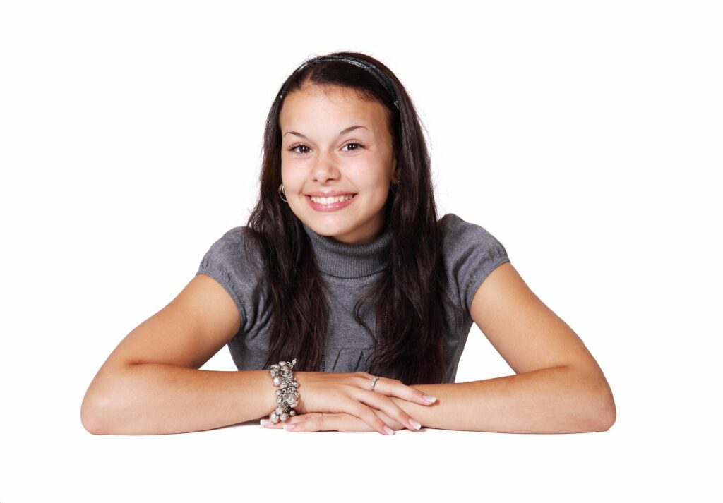 Teenage girl smiling and folding arms