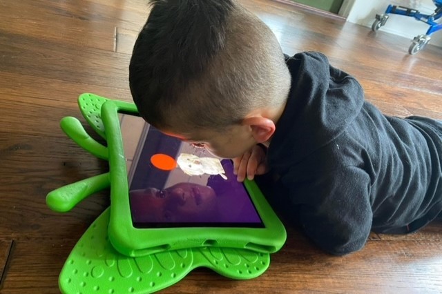 Zane watching the YouTube channel on an iPad