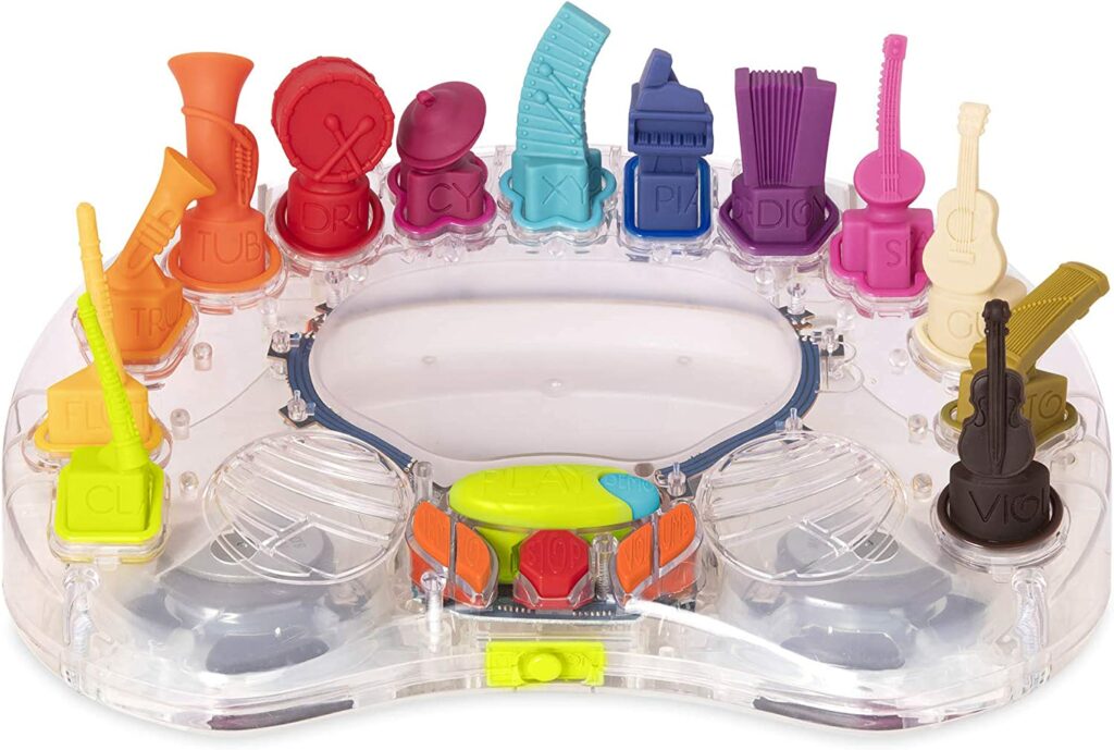 A light up toy with various musical instruments all different colors that are standing up on the outside of the toy. 